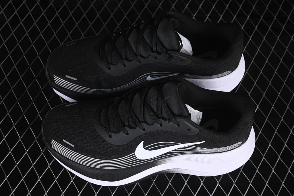 Pair of black and white Nike Journey Run shoes viewed from above