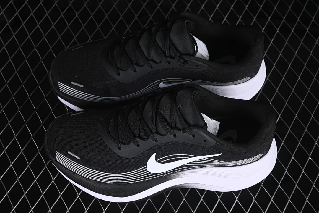 Pair of black and white Nike Journey Run shoes viewed from above