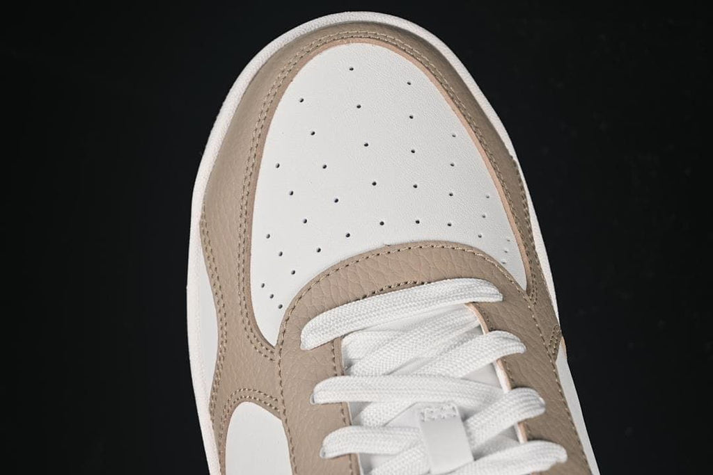 Top view of the perforated toe and lace area
