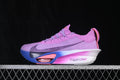 Side view of a purple Nike road-running shoe with blue, pink, and white sole accents.