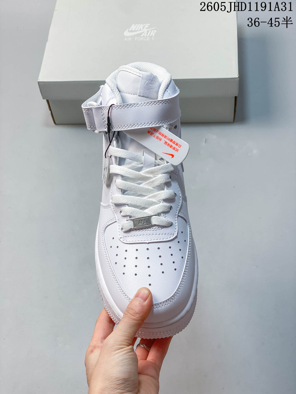 Front view highlighting the white laces, ankle strap and perforated toe box