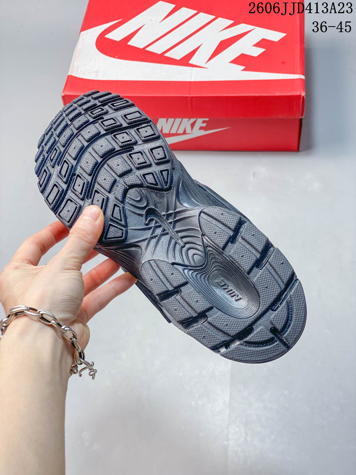 Patterned outsole of a dark charcoal Nike Air Zoom Winflo 12 shoe