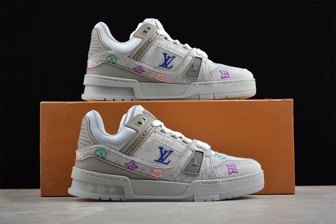 Pair of gray sneakers displayed on an orange shoebox