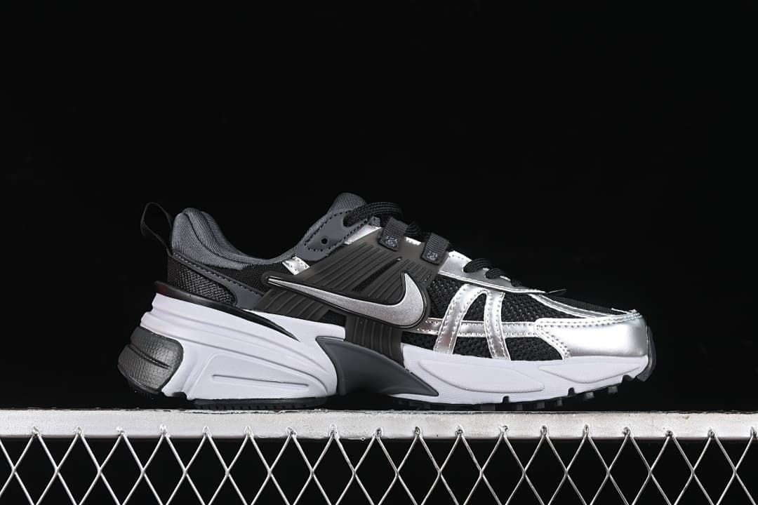 Side profile of the Nike V2K Run sneaker in black, silver, gray, and white