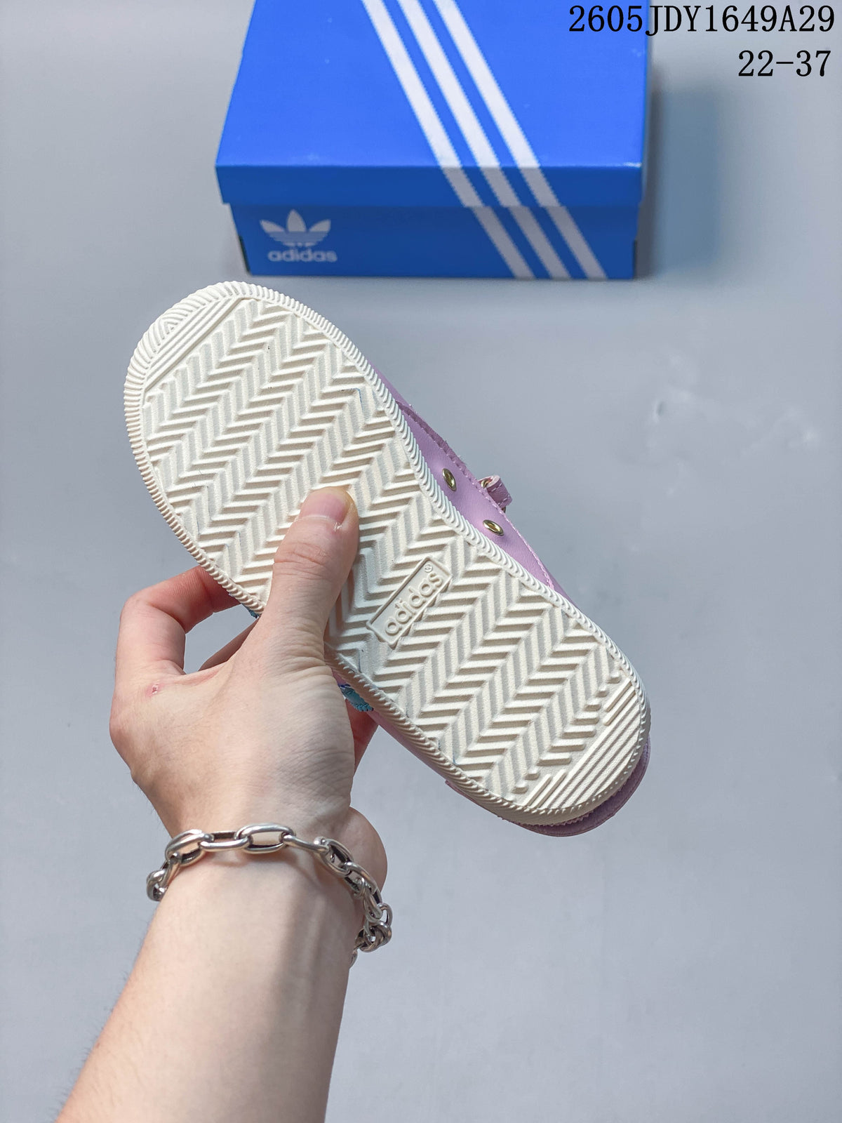 Textured cream-colored outsole of the pink sneakers.