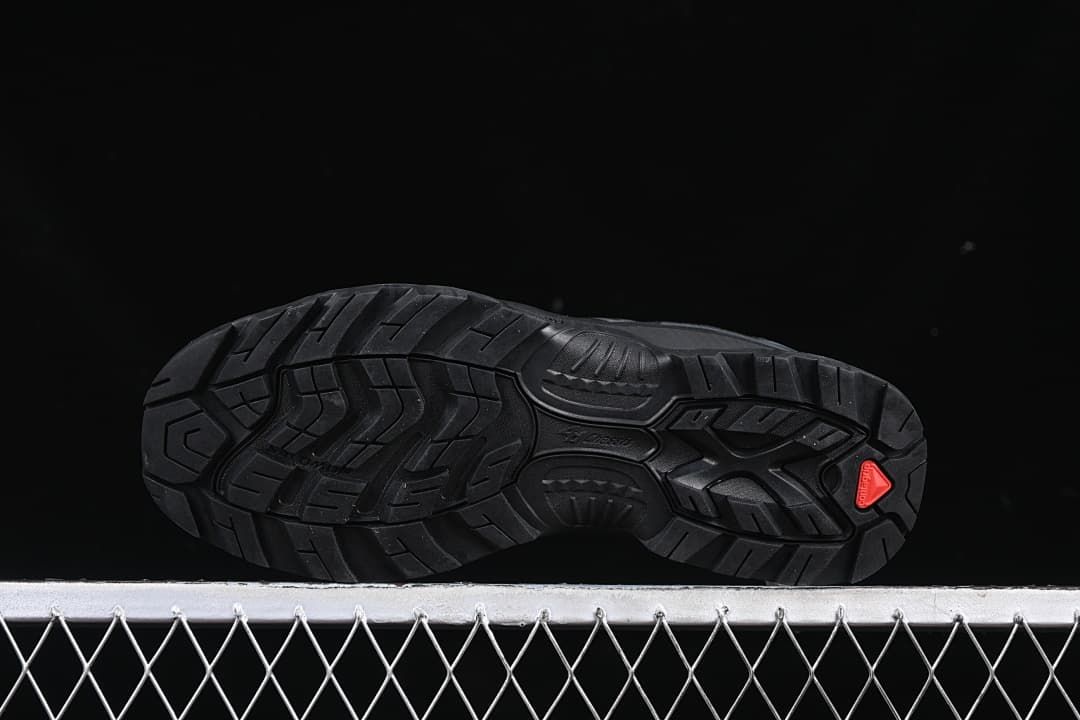 Underside view showing the tread pattern and red heel accent.