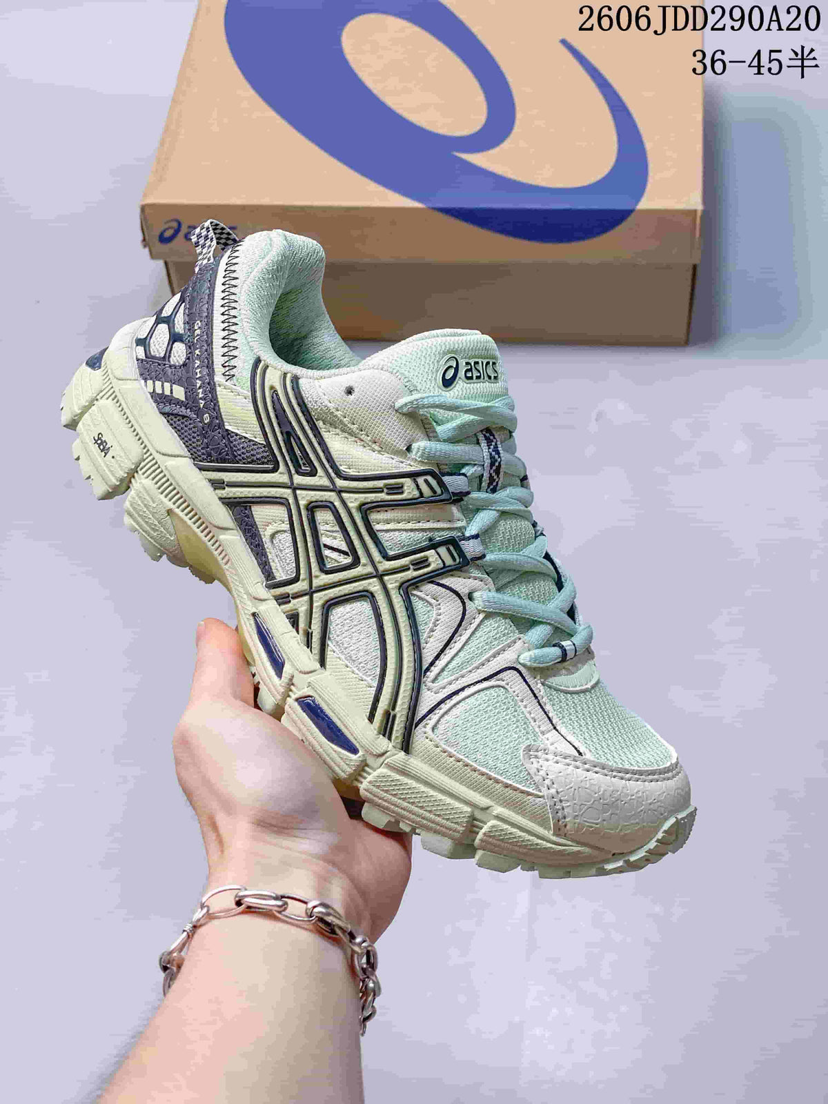 ASICS Gel-Kahana 8 sneaker in pale mint and off-white with dark contrasting side details.