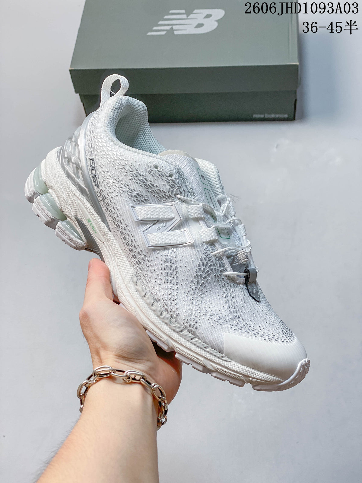 All-white New Balance 1906U sneaker with a textured upper