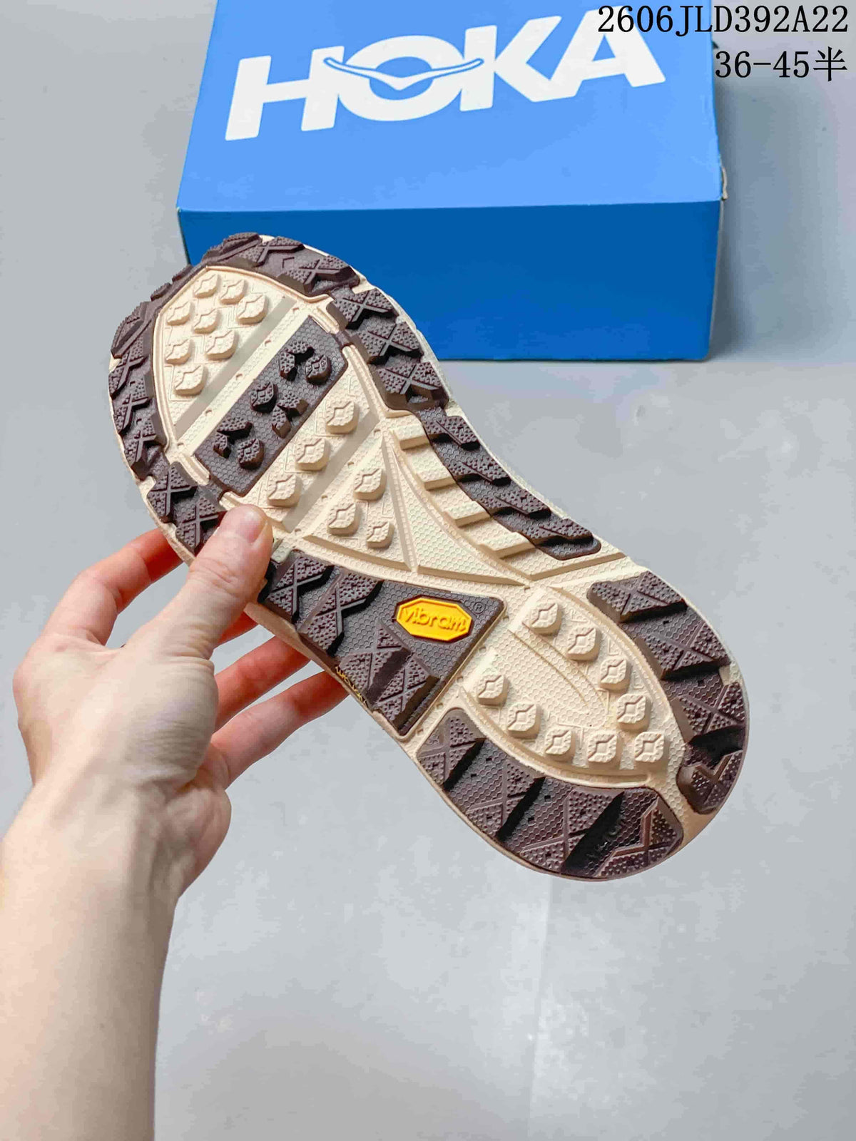 Close-up of the lugged outsole with a Vibram badge on a HOKA Tor Summit sneaker.
