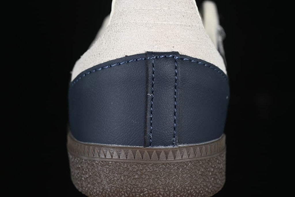 Rear close-up of the navy heel panel and dark outsole