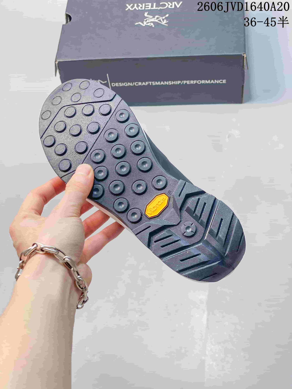 Close-up of the shoe's lugged outsole with a Vibram badge