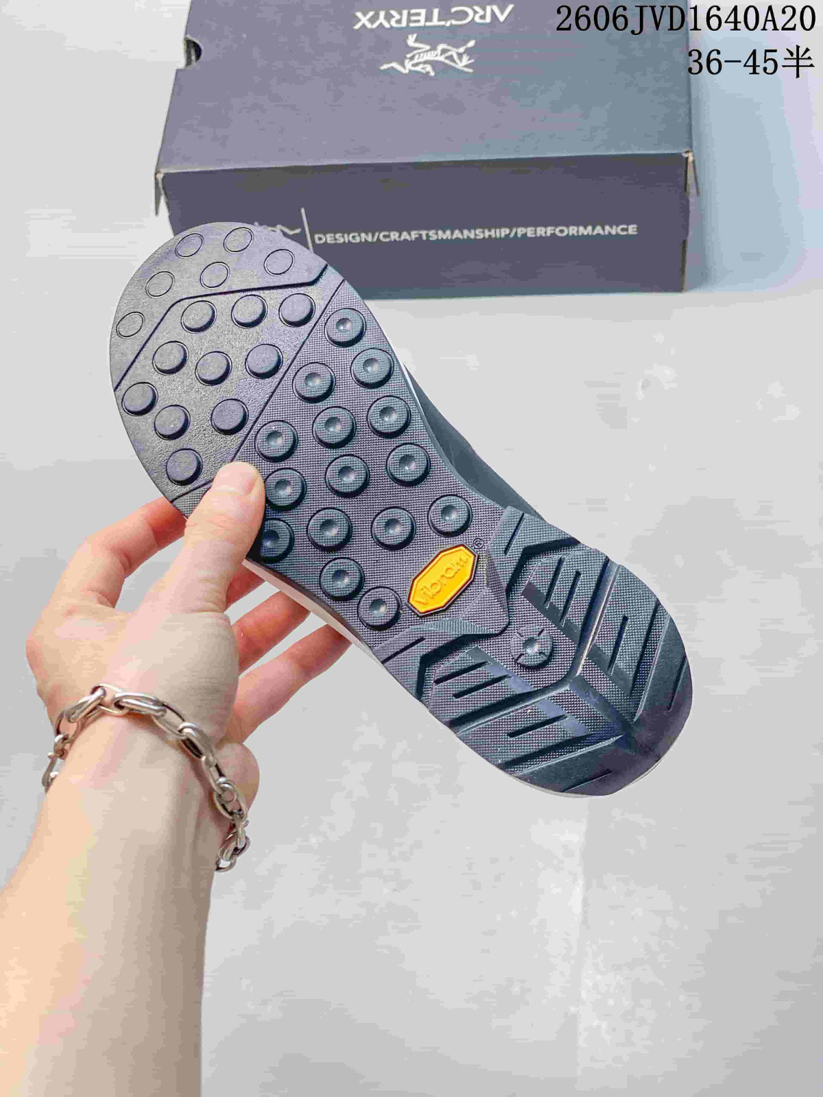 Close-up of the shoe's lugged outsole with a Vibram badge