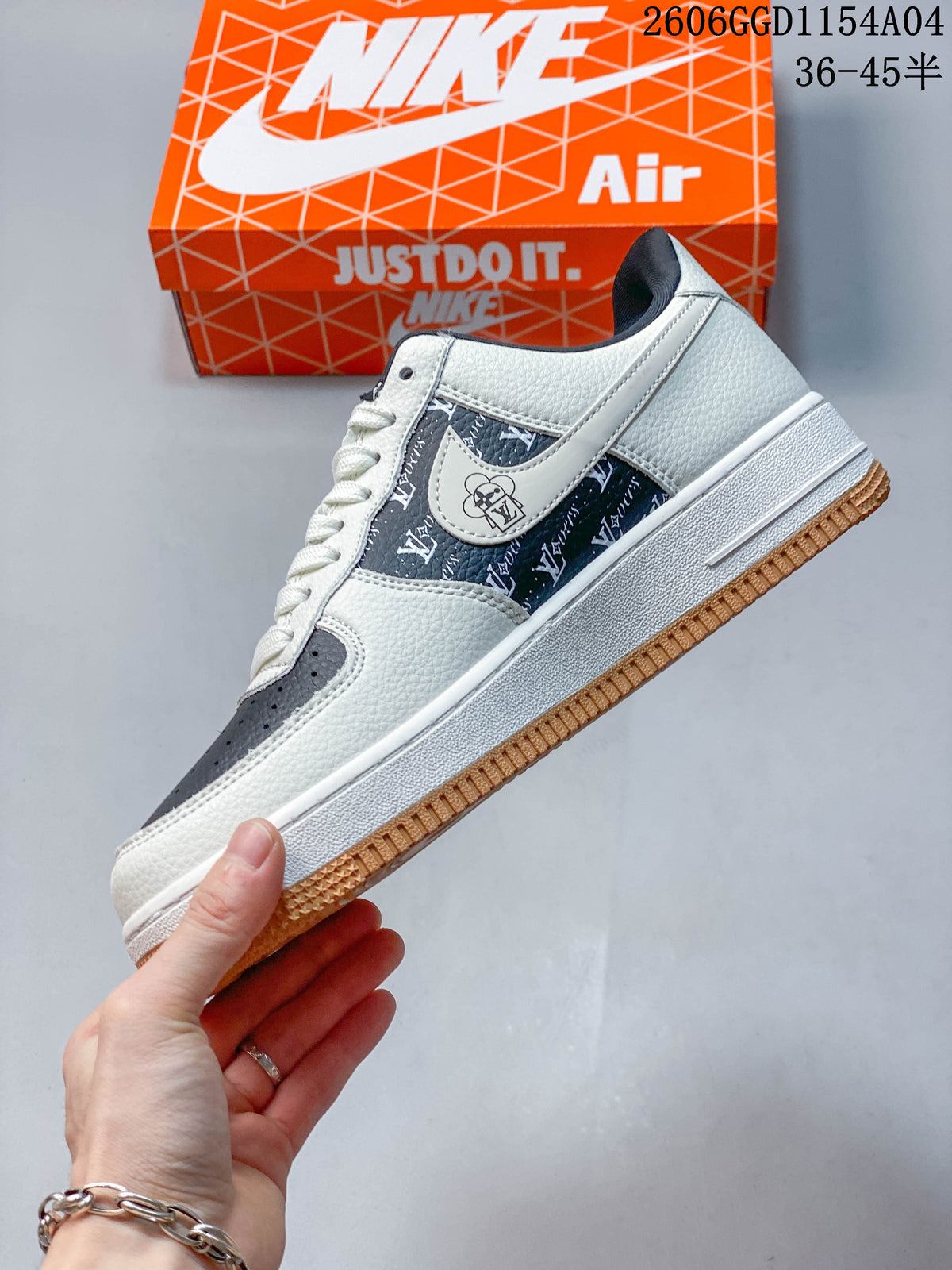 Side view of a white and navy low-top sneaker with patterned panels and gum-colored outsole.