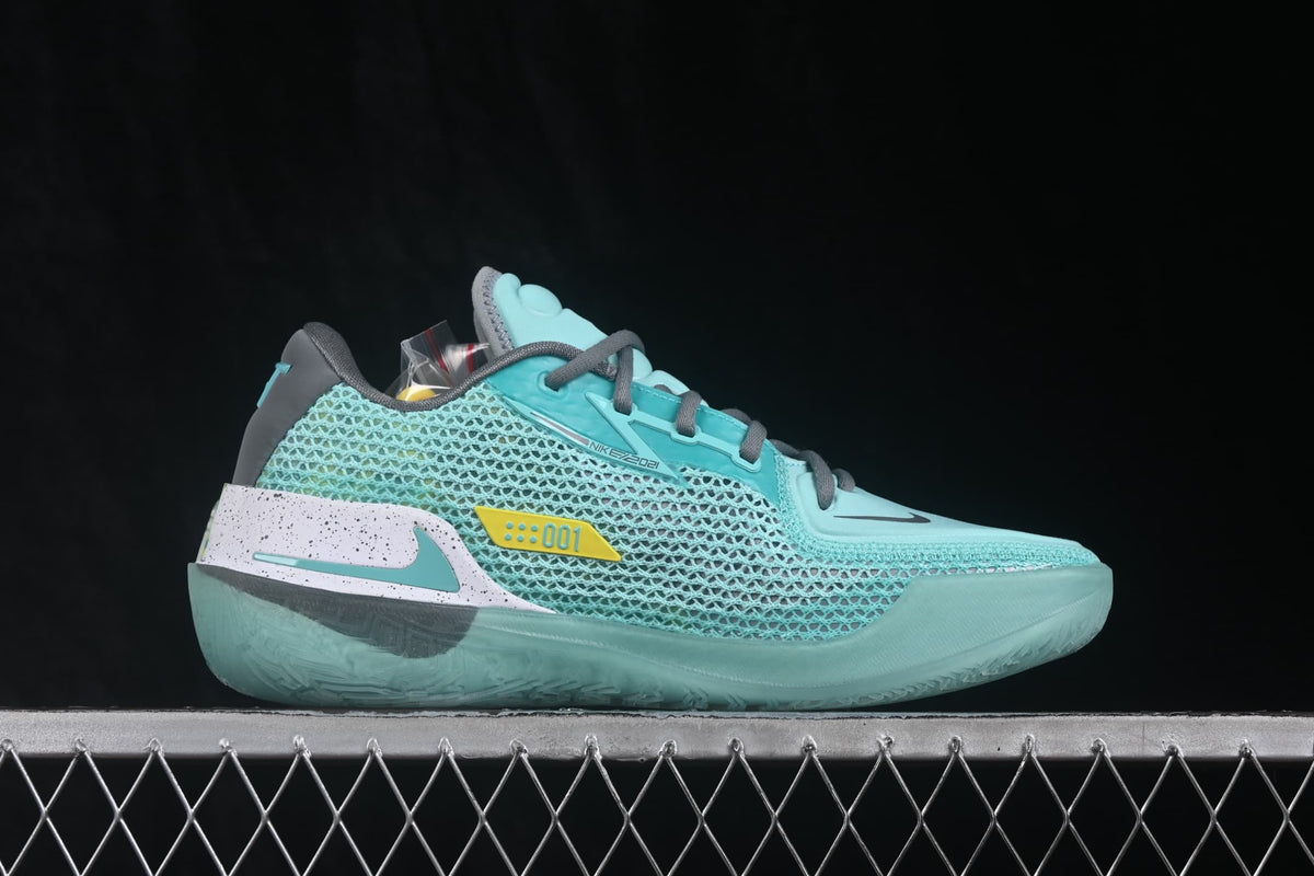 Side profile of a turquoise Nike Air Zoom G.T. Cut basketball shoe with textured side panels, dark Swoosh, and white-speckled heel detail.