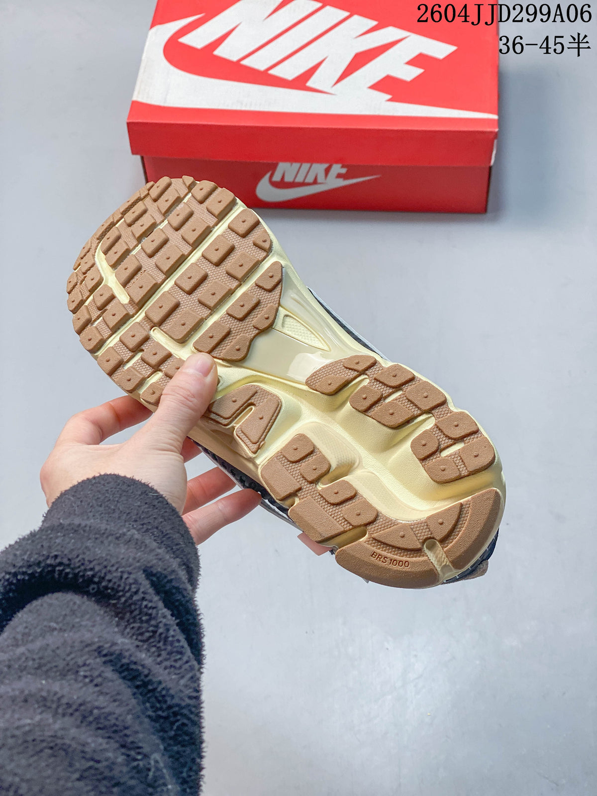 Underside of a sneaker showing a tan segmented outsole and pale midsole