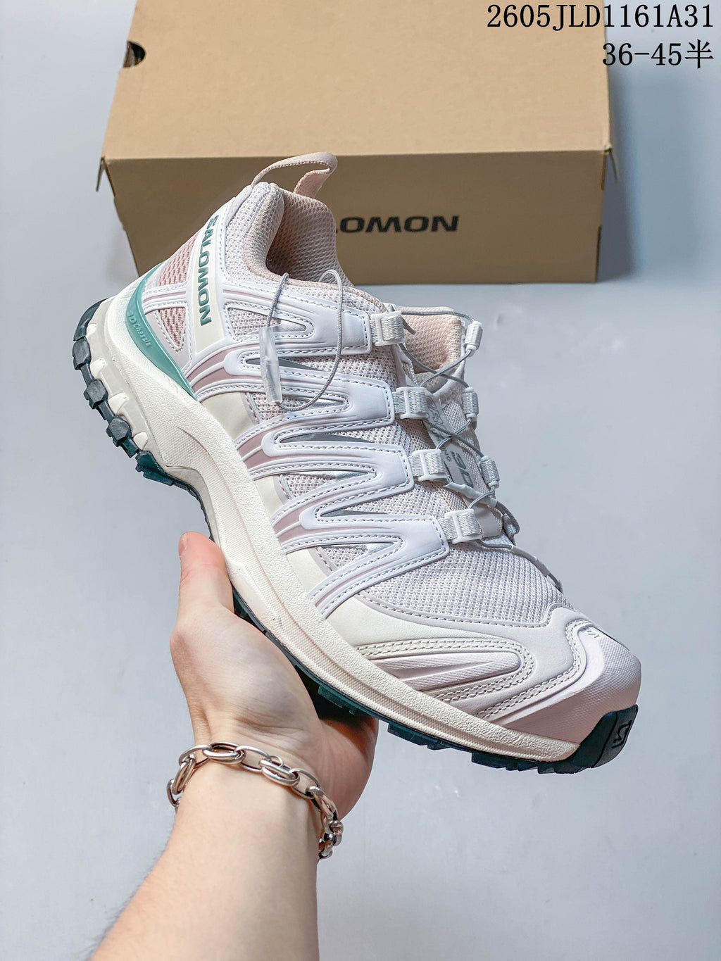 Side view of a white Salomon XA Pro 3D sneaker showing its quick-lace closure and lugged outsole.