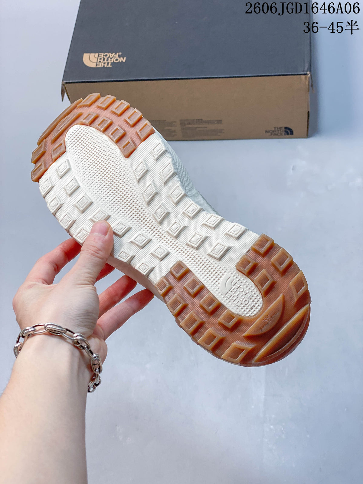 Underside of the mule showing a brown-and-cream treaded outsole