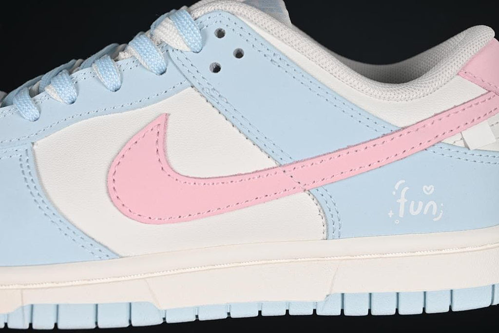 Close-up of pink Swoosh and blue and white side panels
