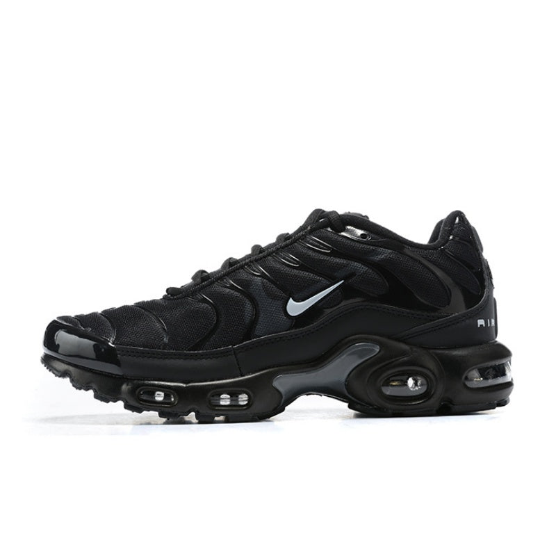 Black Nike Air Max Plus sneaker with a light-colored swoosh and visible air units.