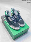 Pair of navy, grey, and green Air Jordan 3 mid-top sneakers shown from the front three-quarter view