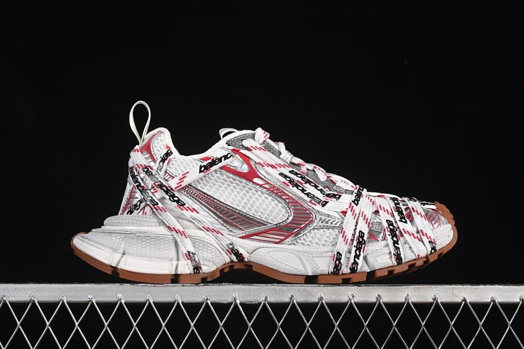 Side profile of a sneaker showing its layered lace design and textured upper