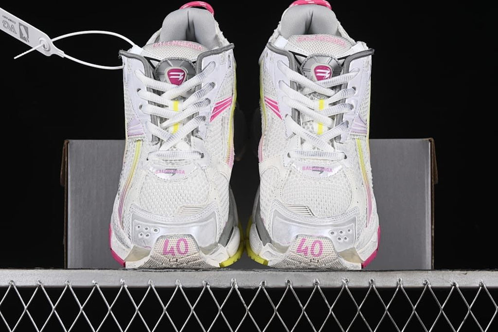 Front view of the pair showing mesh uppers, laces, and pink accents.