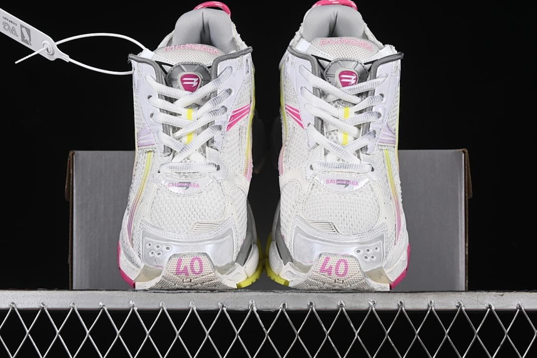 Front view of the pair showing mesh uppers, laces, and pink accents.