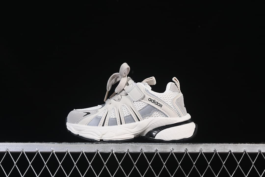 White and grey adidas Adistar kids’ sneaker shown from the side