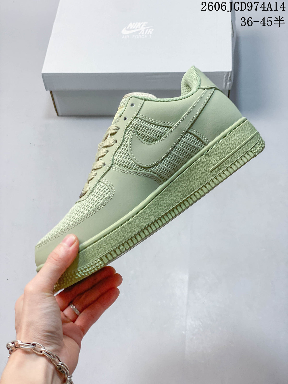 Side view of a pale green low-top sneaker with woven-look panels and tonal overlays