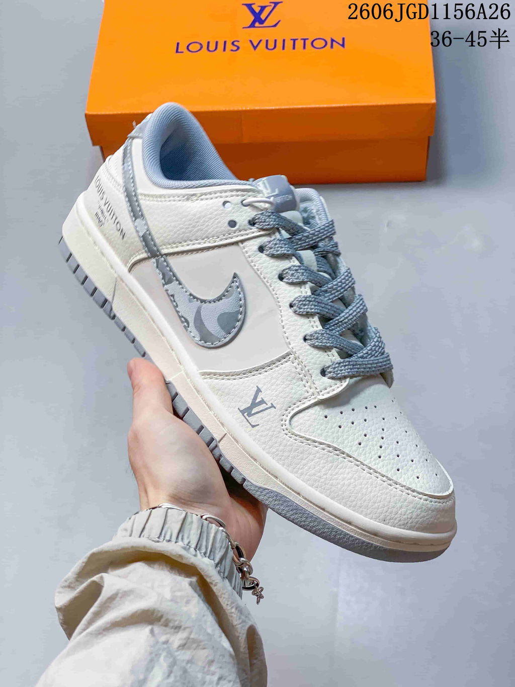Close-up of a white low-top sneaker with gray patterned side detail and gray laces
