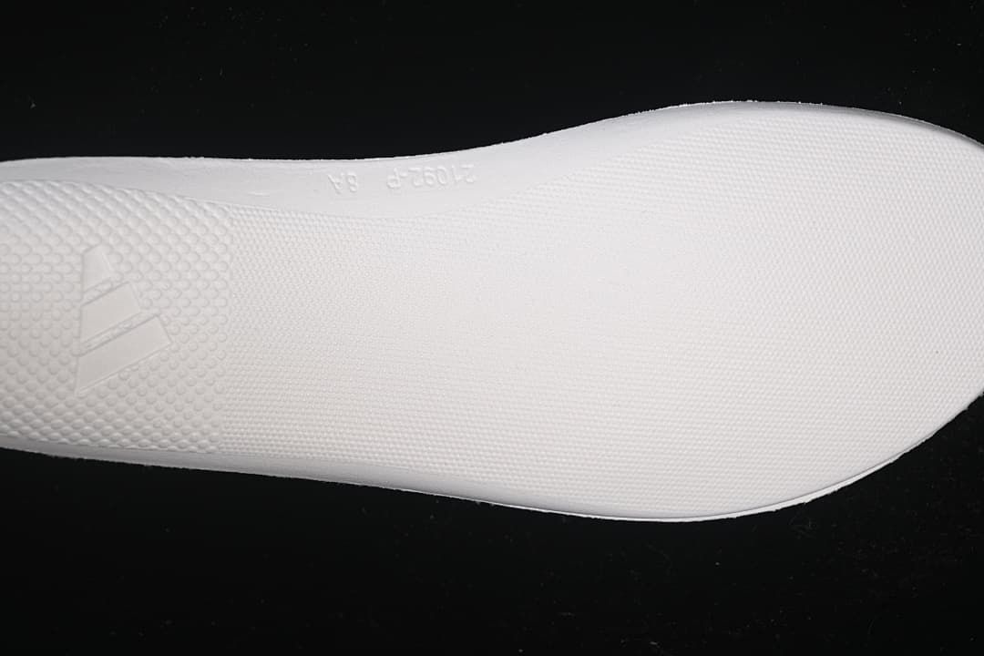 Close-up of the white shoe sole and embossed detailing.