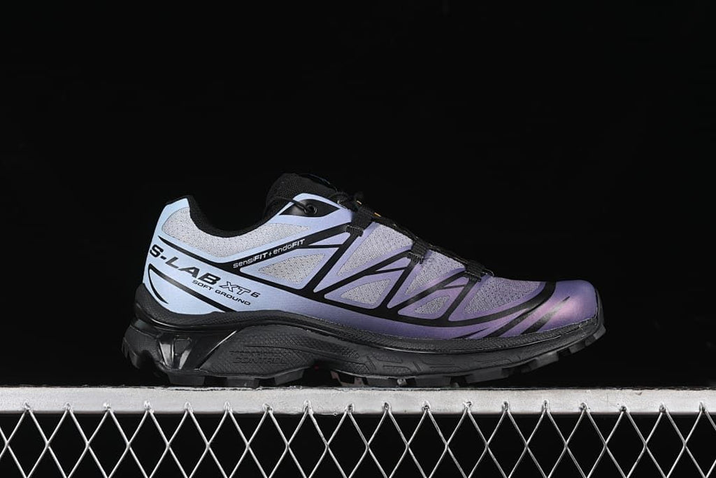 Side profile showing the XT-6 shoe's gray-violet upper and black sole.