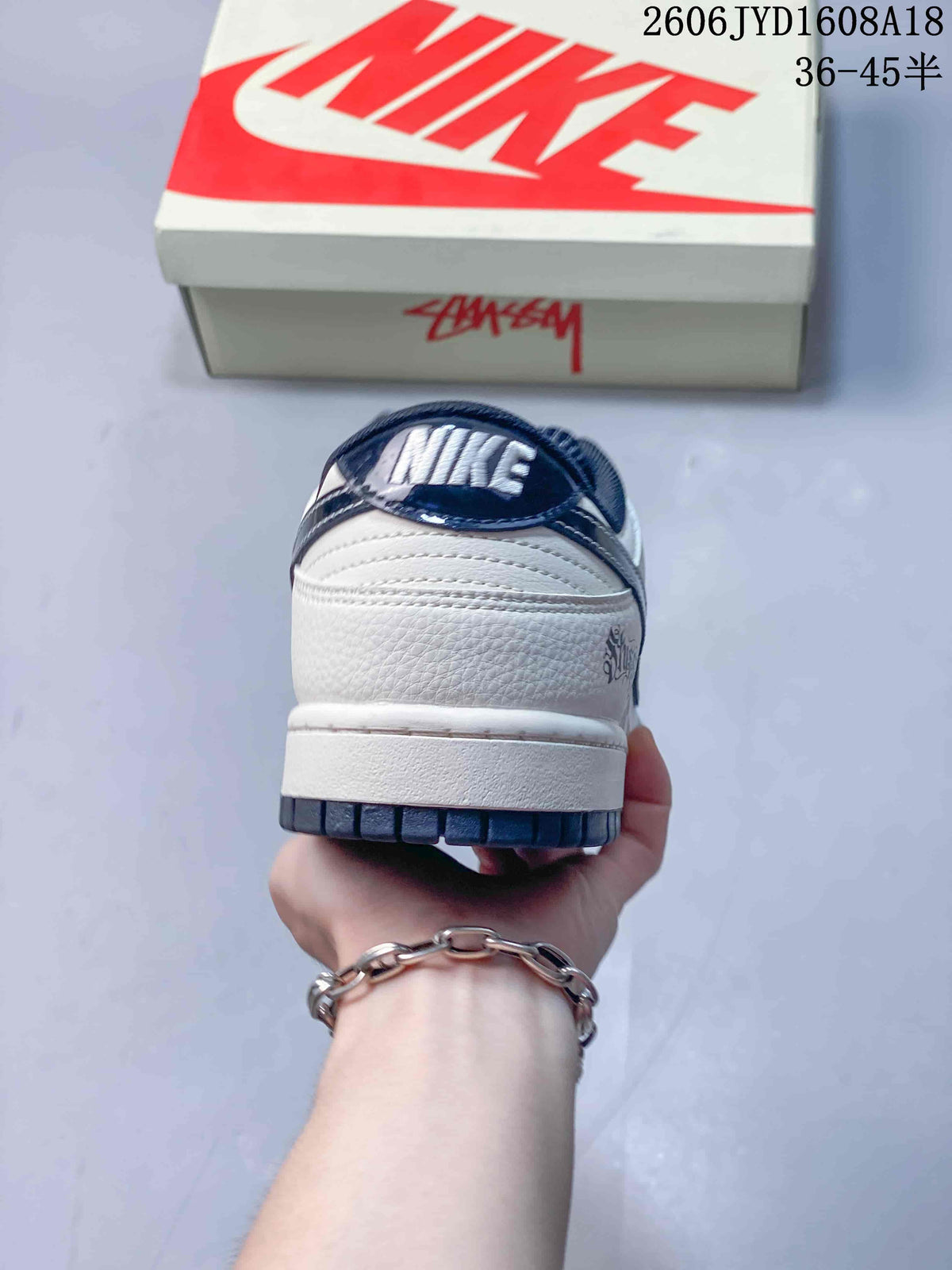 Rear view showing the heel, white midsole, and navy outsole