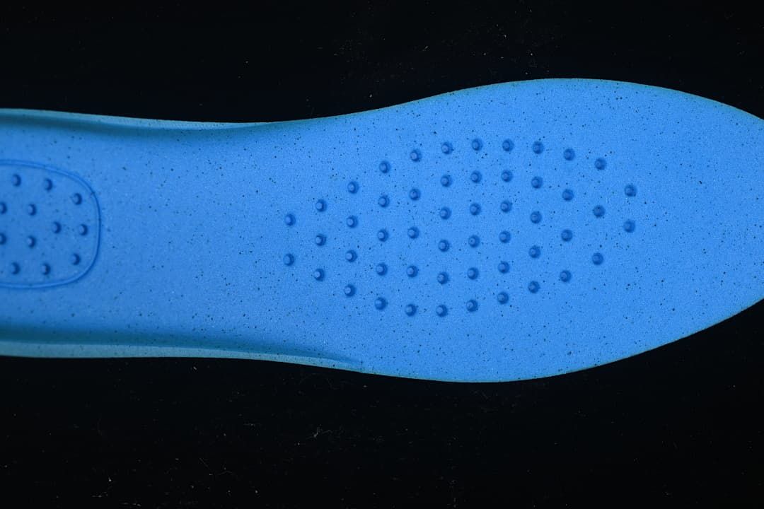 Blue insole surface with a pattern of raised circular details
