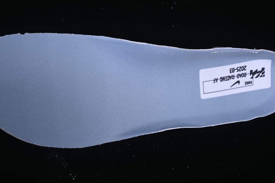 Blue-grey shoe insert with a printed Nike road racing label