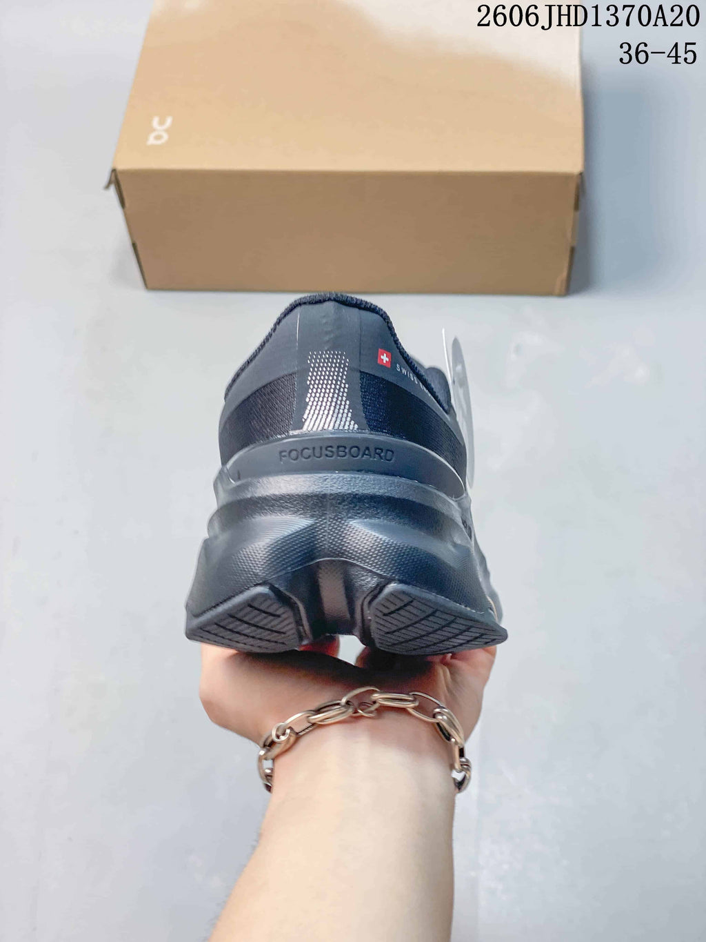 Rear view of a charcoal gray sneaker with a sculpted heel and sole.