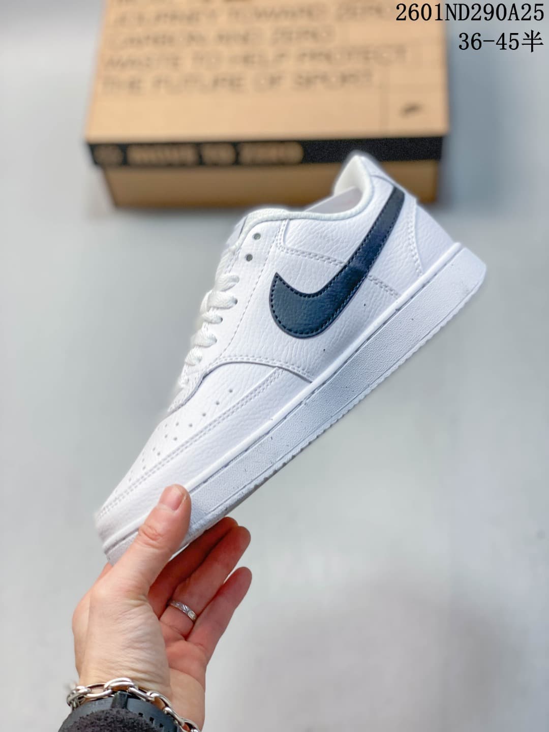 Side view of a white Nike low-top sneaker with a dark Swoosh