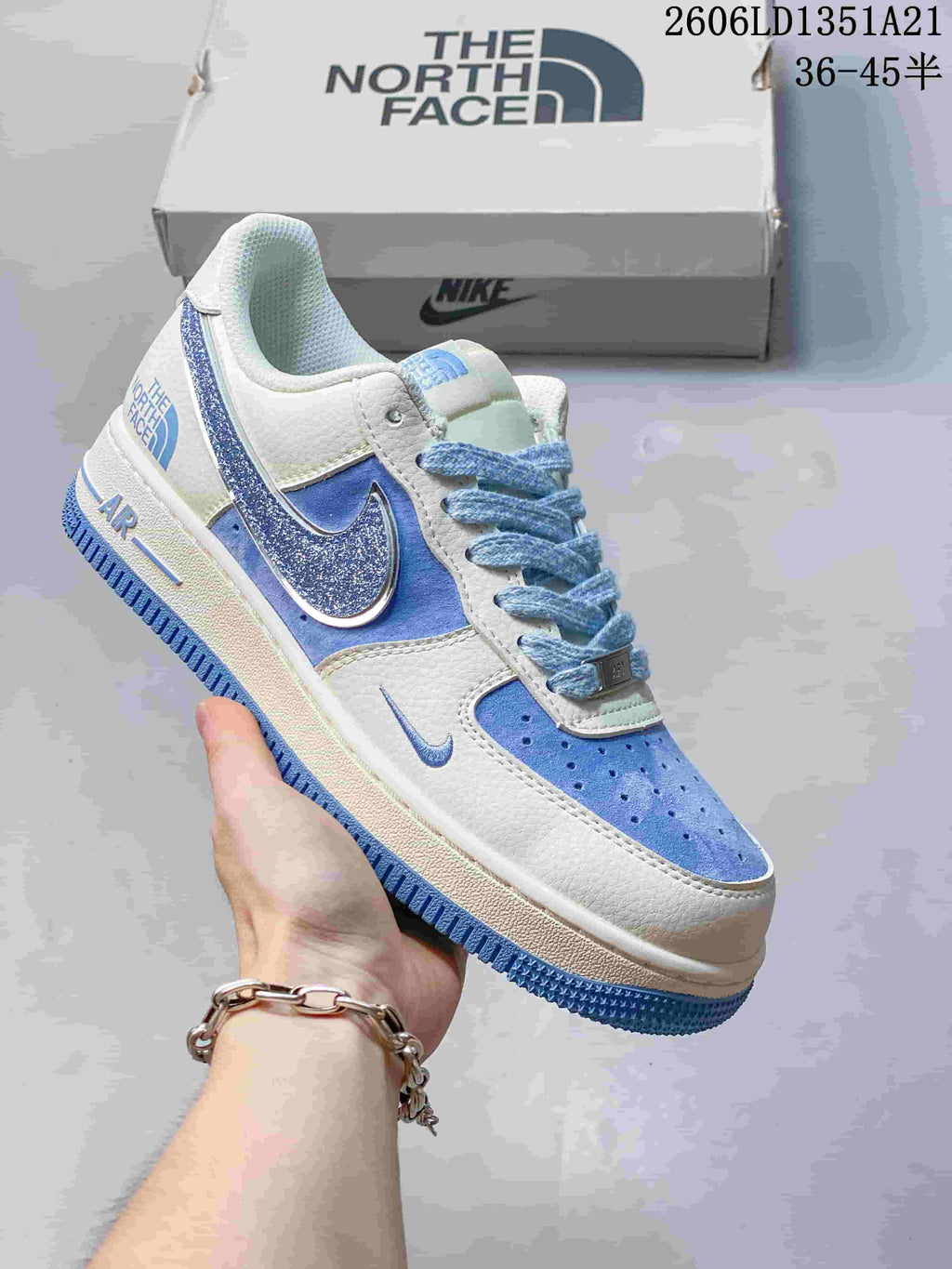 White low-top sneaker with blue glitter Swoosh and light blue accents