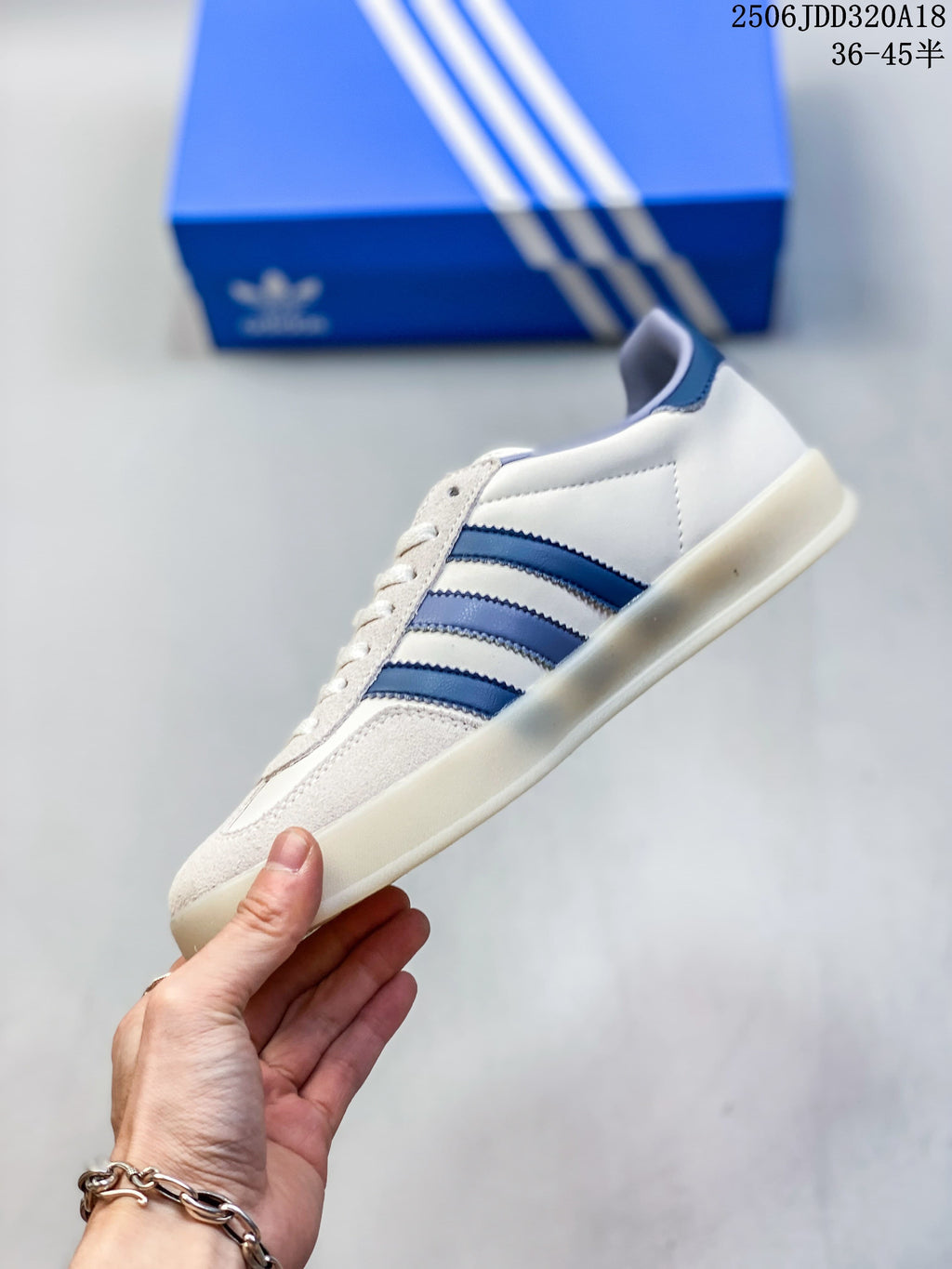 Side view of the cream low-top sneaker with blue stripes and a light outsole.