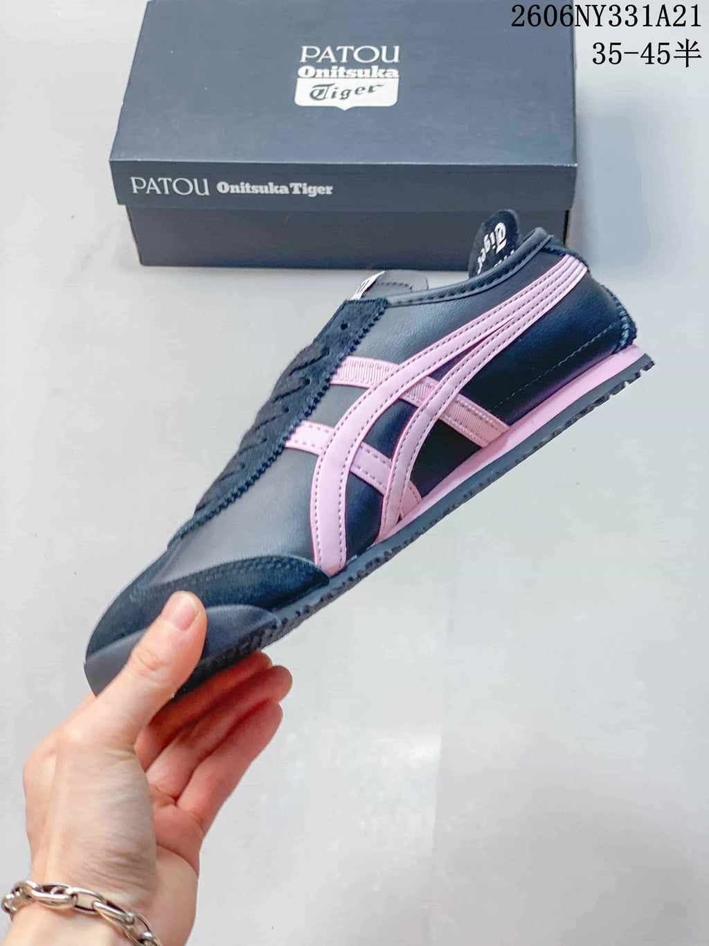 Side profile of a navy and pink Onitsuka Tiger Mexico 66 Deluxe sneaker