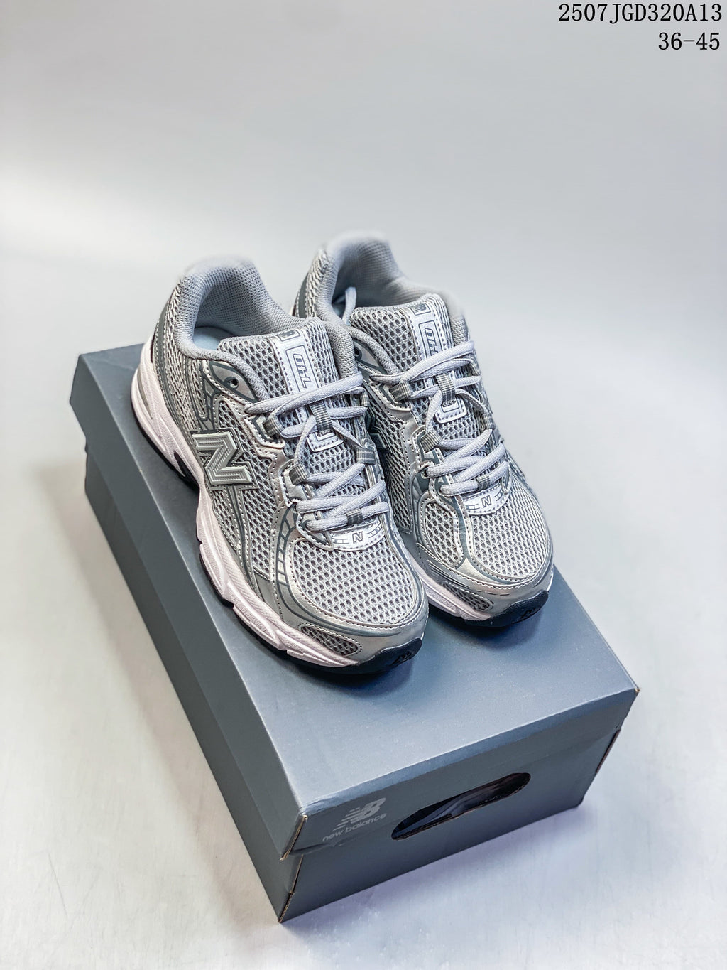 Pair of silver and grey New Balance 740 sneakers on a shoebox