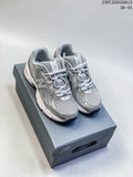 Pair of silver and grey New Balance 740 sneakers on a shoebox