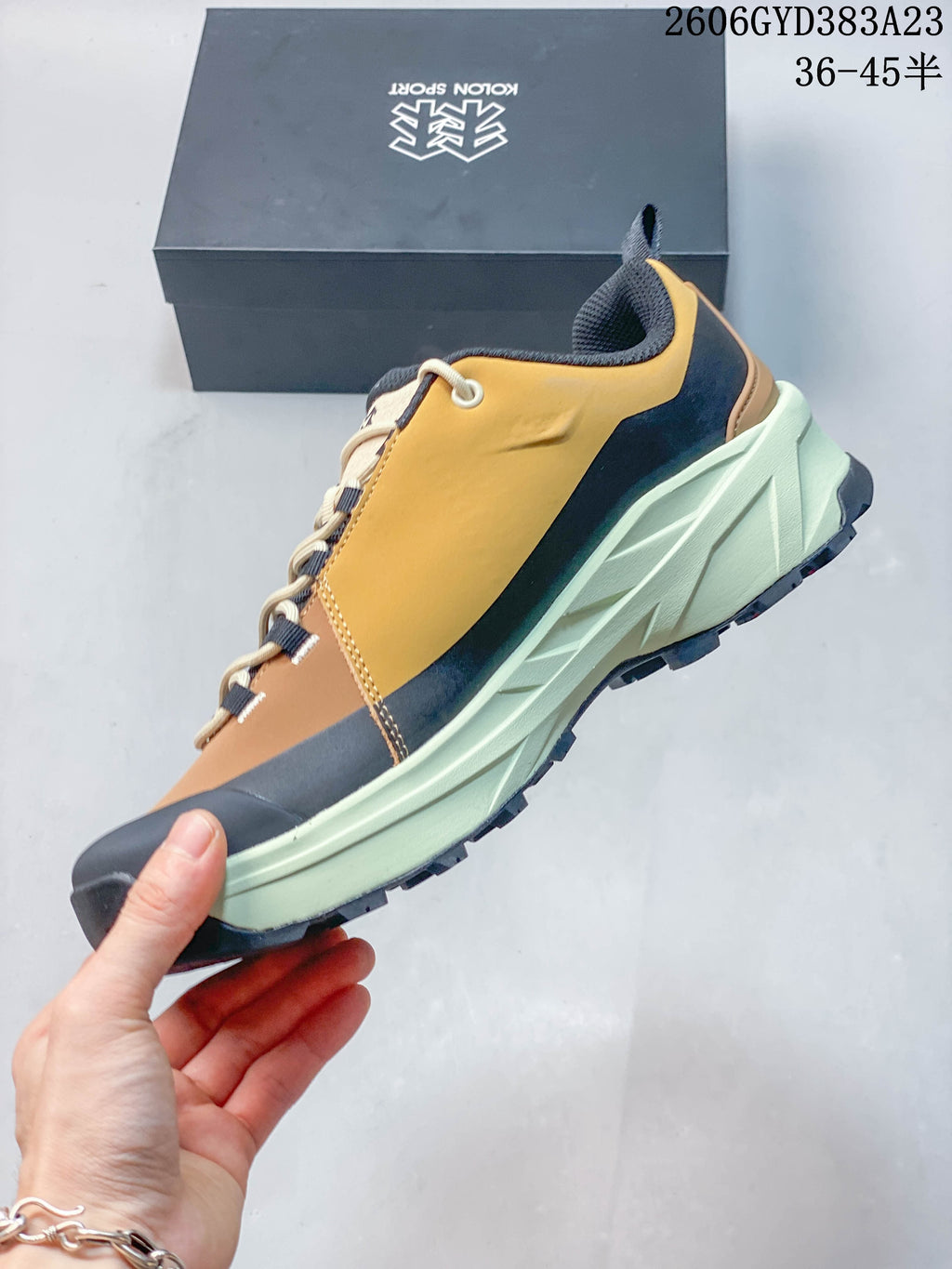 Side view of the shoe with layered panels and a lugged outsole
