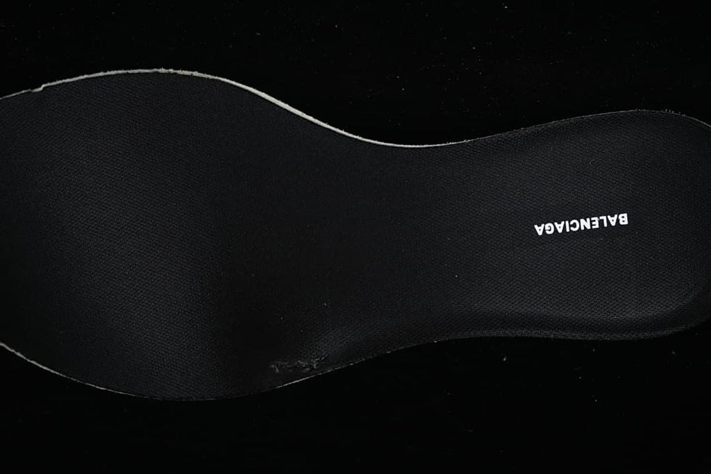 Black shoe insole with a printed brand name