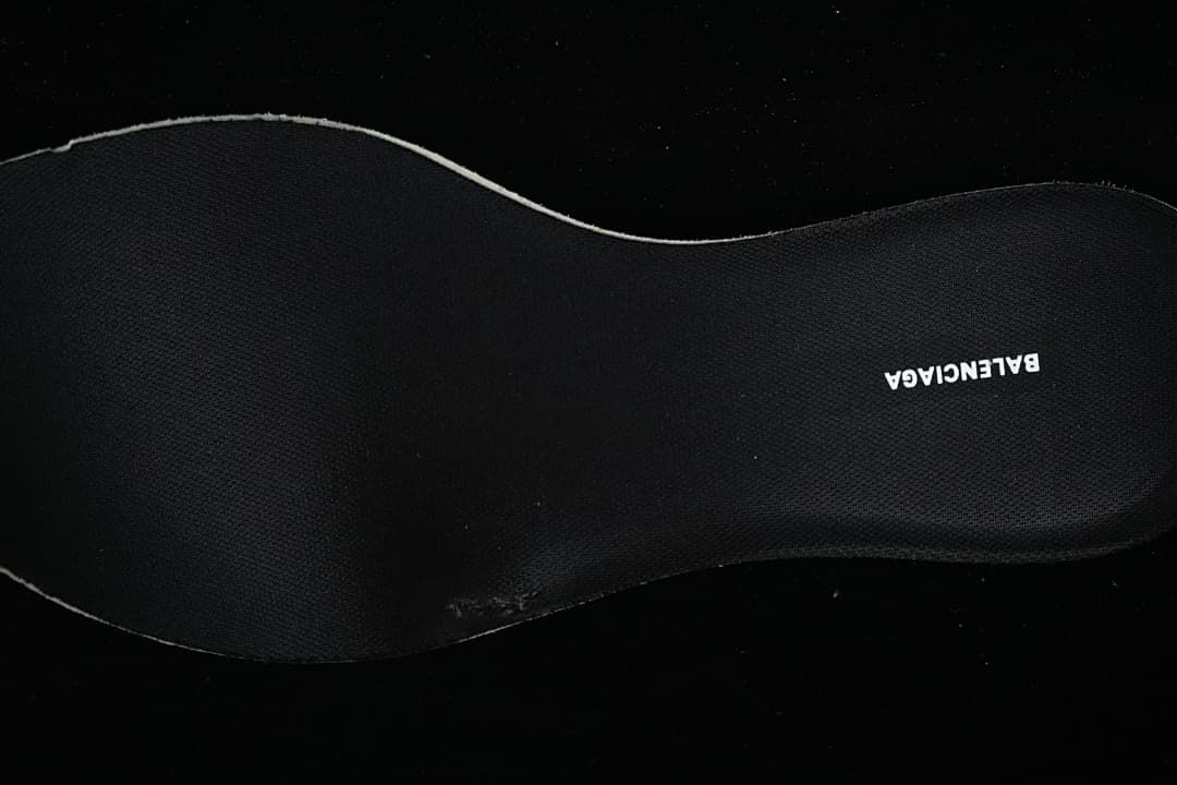 Black shoe insole with a printed brand name