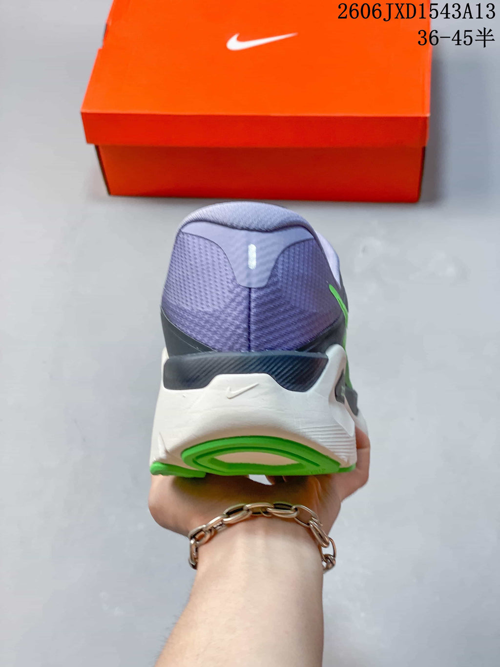 Rear view of a Nike Structure Plus running shoe with a lavender heel and green outsole accents.