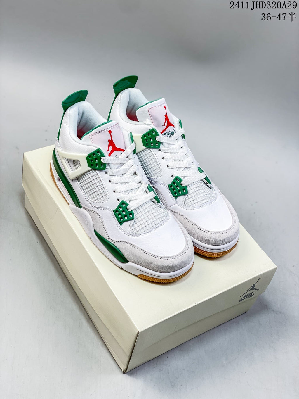 Pair of white and green Air Jordan 4 Retro OG sneakers shown from the front on a box