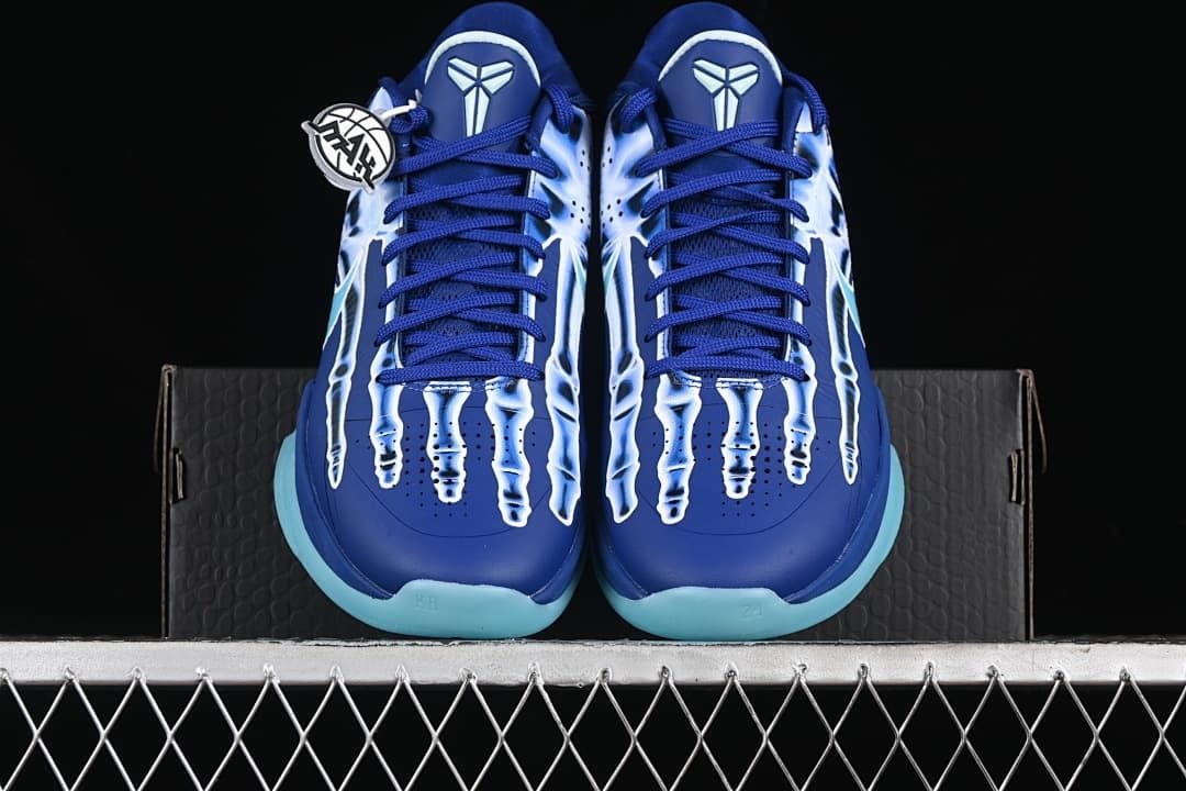 Front view of both shoes showing skeleton graphics and aqua outsole edges
