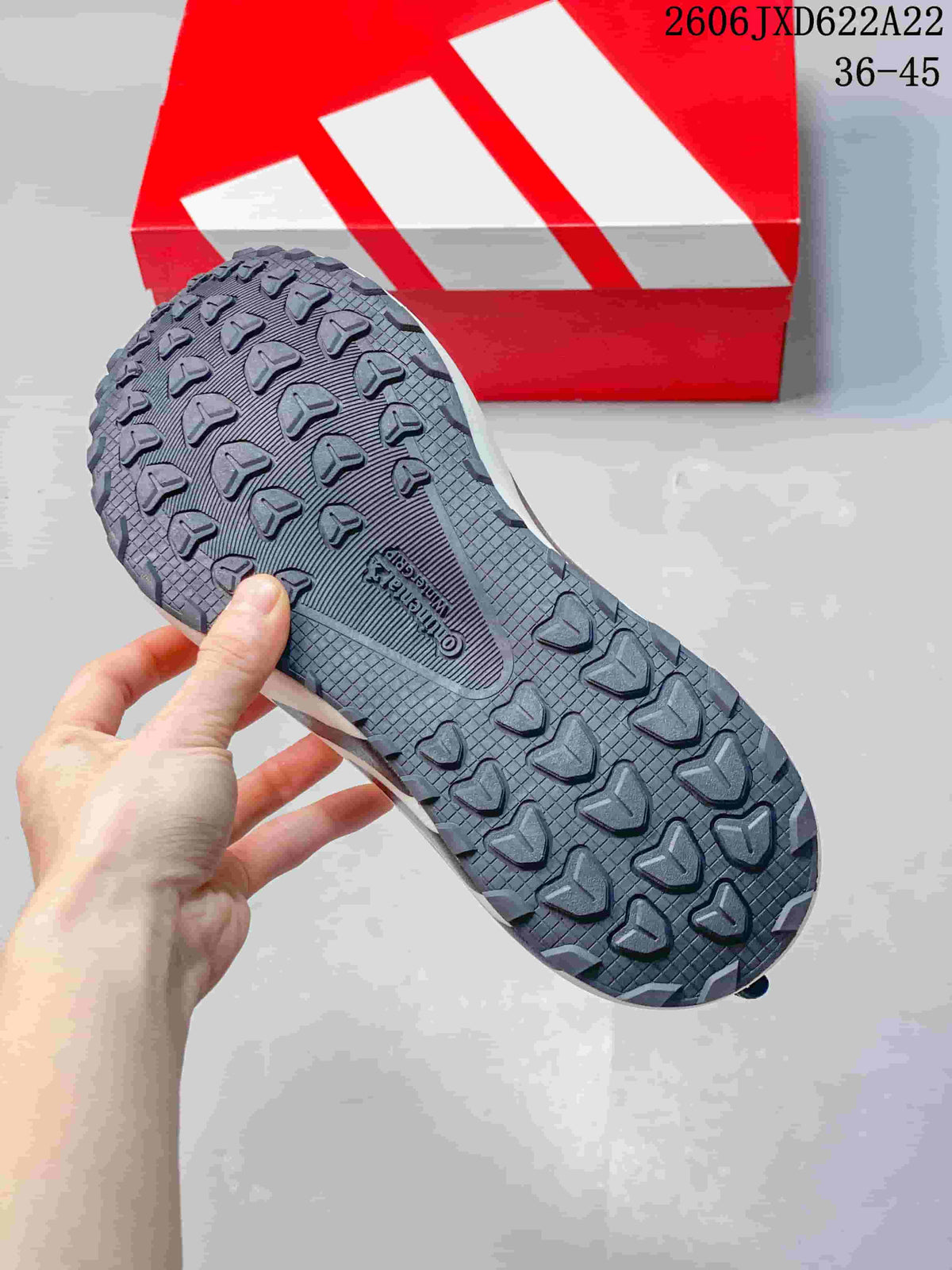 Close-up of the gray sneaker's patterned outsole.