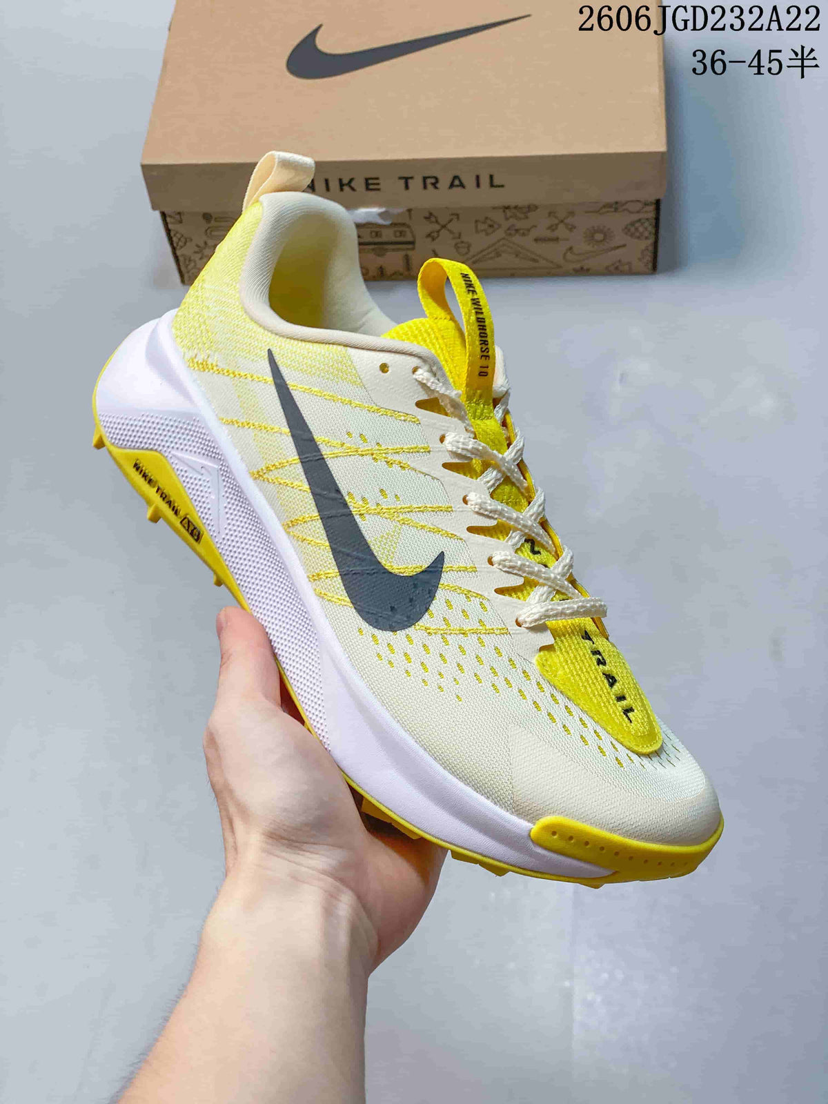 Side view of a light Nike Wildhorse 10 trail-running shoe with yellow accents and a trail-style outsole.